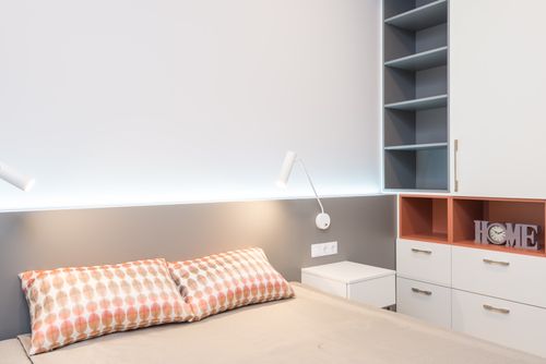 Free Comfortable bed with cushions and minimalism lamps above nightstands in cozy bedroom with white furniture Stock Photo