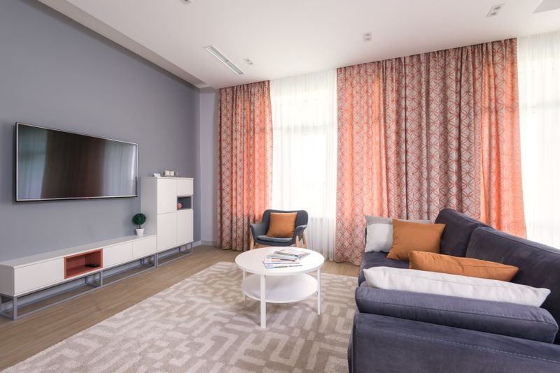 Staged spacious living room with sofa and armchair