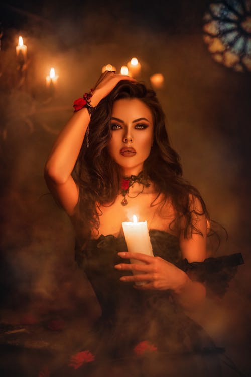 Free Alluring Woman holding a Lighted Candle  Stock Photo