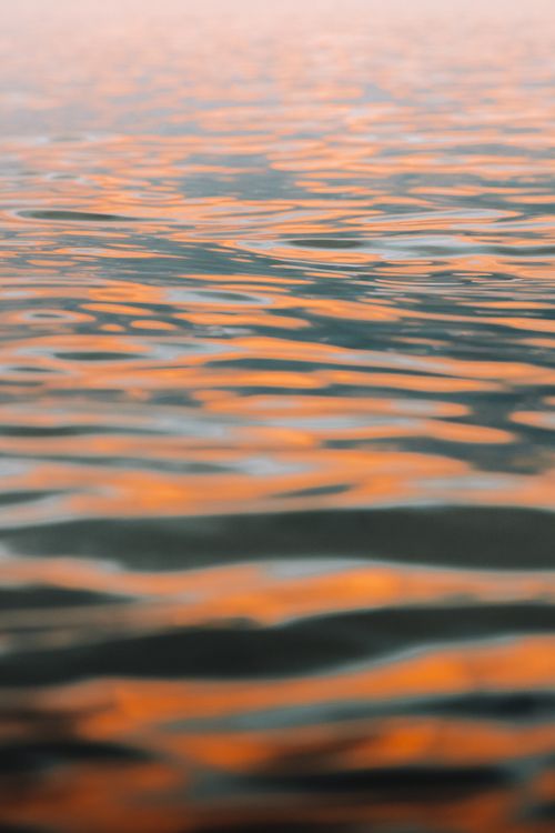 Free Stunning view of orange sunset reflections on a calm sea at McCrae, Australia. Stock Photo