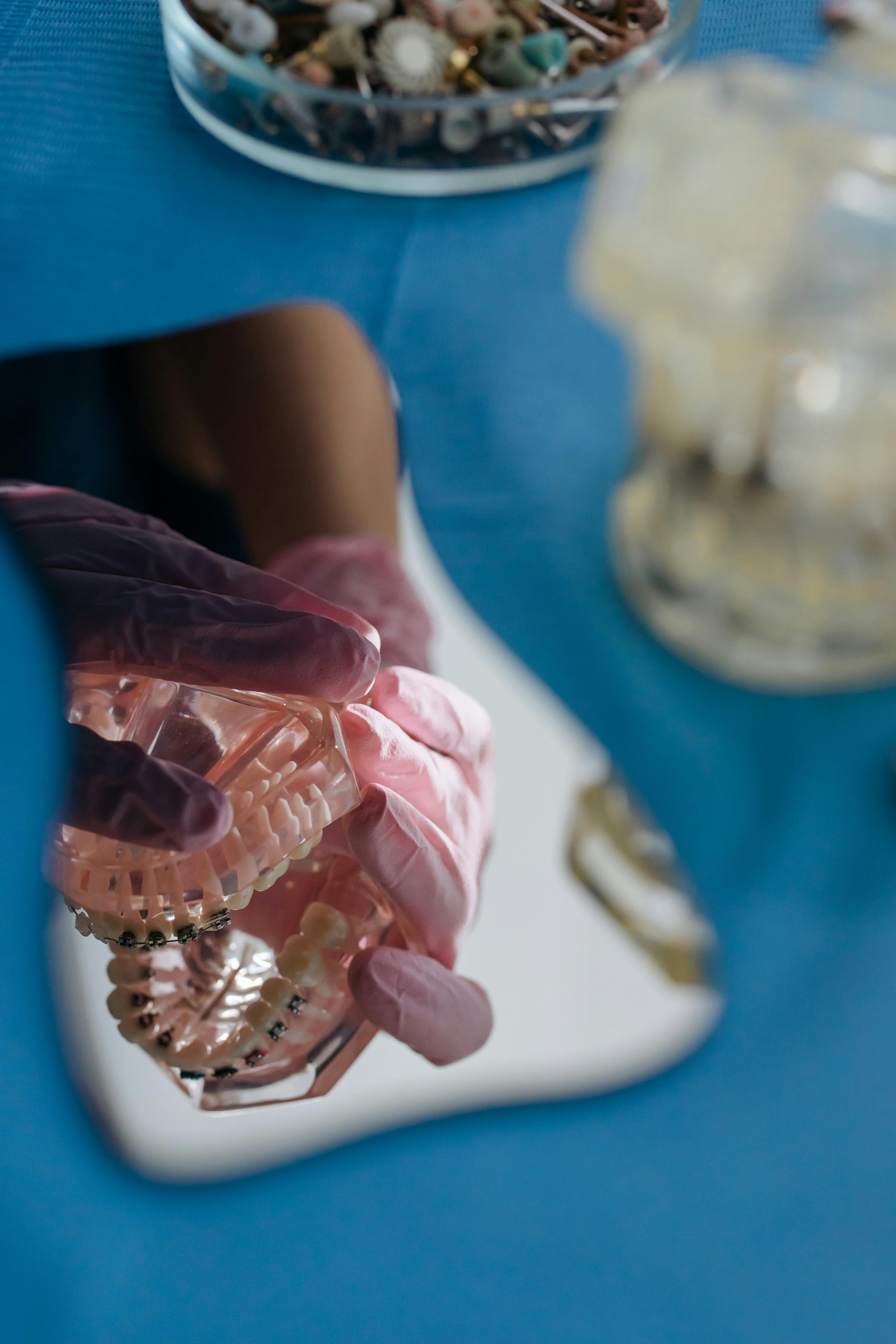 person holding plastic jaws reflecting in the mirror