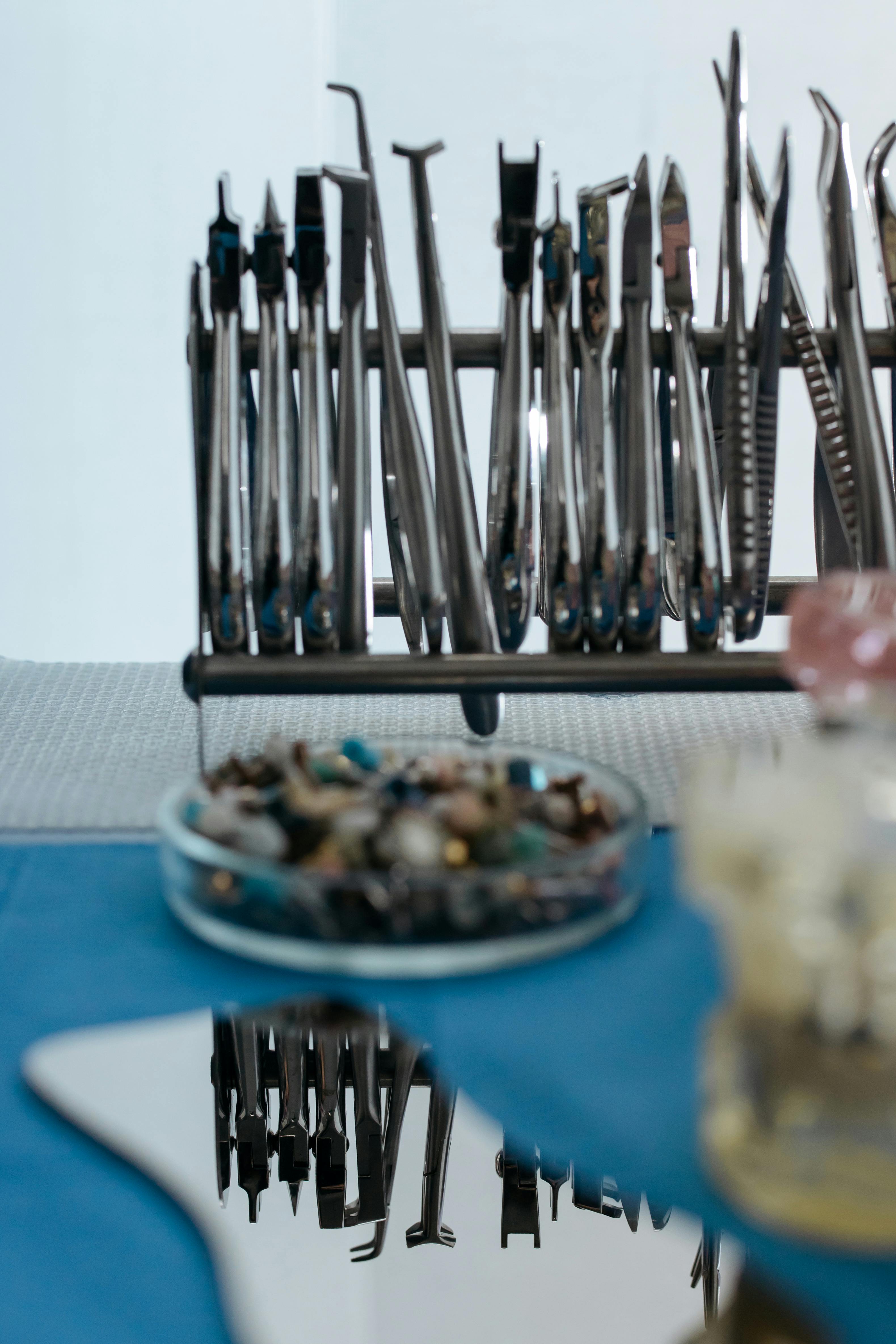 steel dental instruments in a row reflecting in the mirror