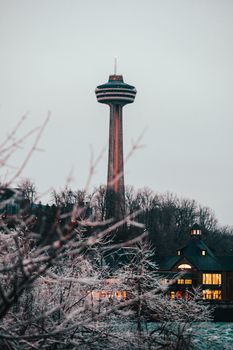 Scenic view of Skylon Tower amidst a snowy backdrop, captured during winter's twilight in Canada.