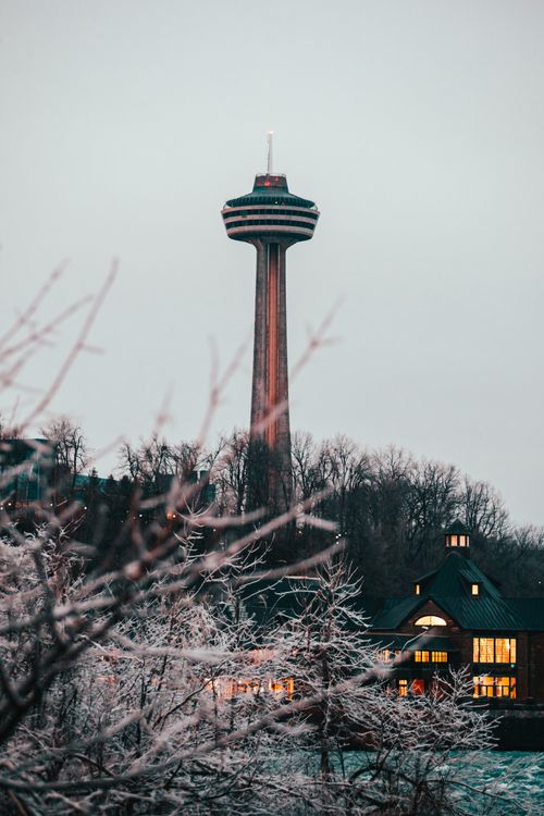 Free Scenic view of Skylon Tower amidst a snowy backdrop, captured during winter's twilight in Canada. Stock Photo