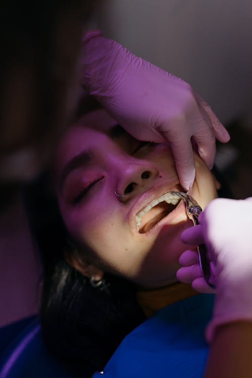 Free Patient receives a Treatment from a Dentist  Stock Photo