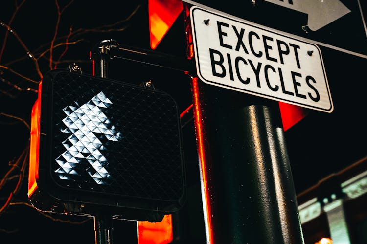 Except Bicycles Road Sign And Traffic Light At Night