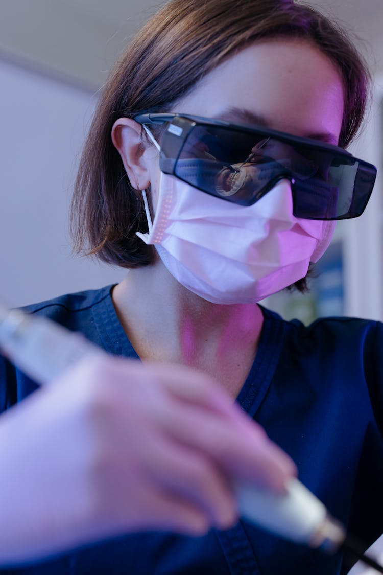 Dentist Wearing Facemask And Eye Protection