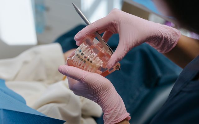 Clear aligner and teeth alignment model being fitted at Smile Point dental clinic