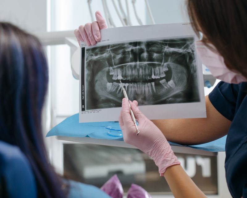 A dentist and patient looking at a dental scan together