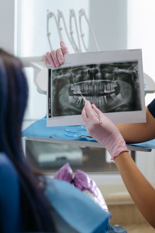 Free Dentist showing an X-ray Image on a Patient Stock Photo