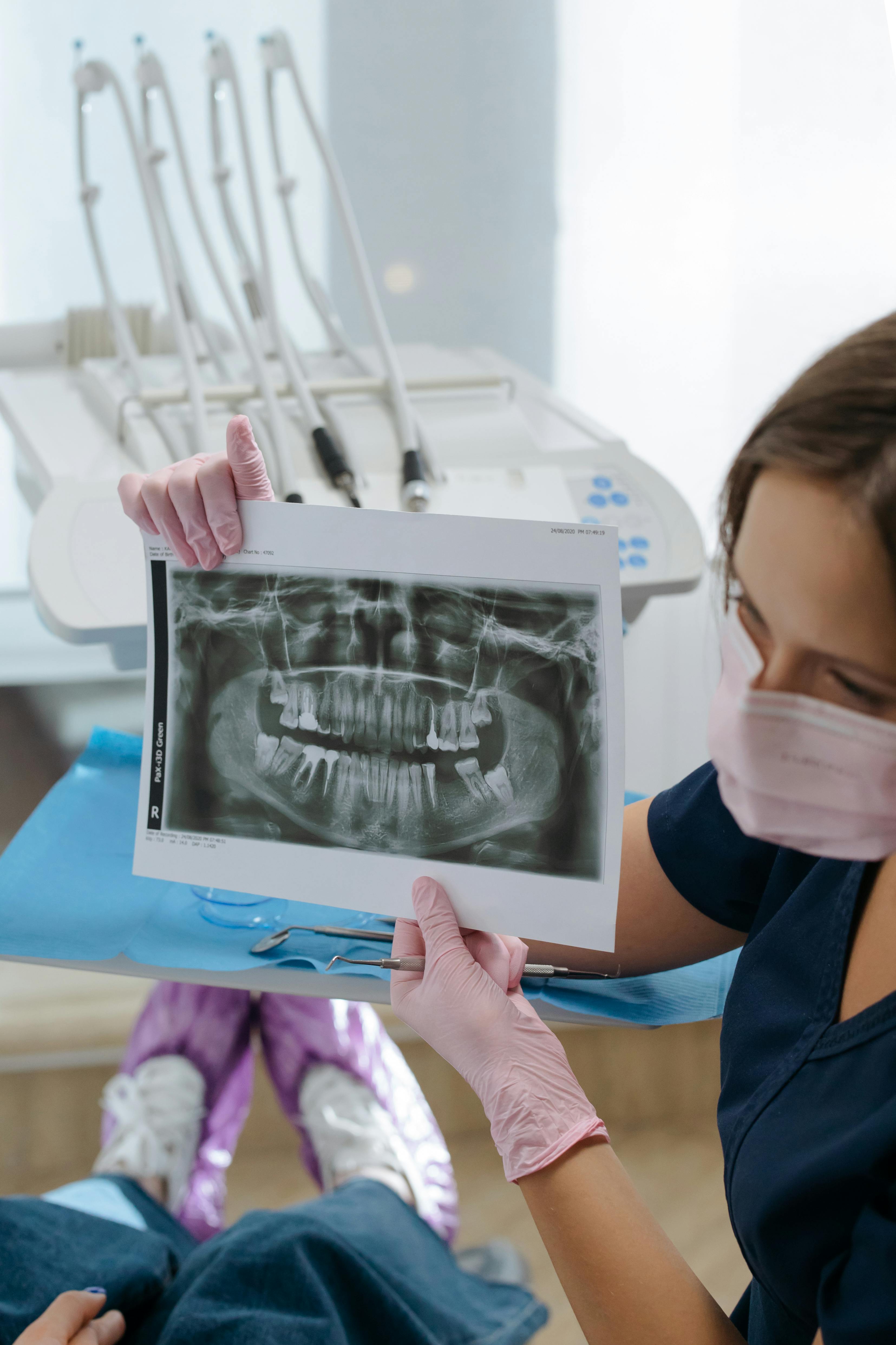 dentist showing an x ray image on a patient