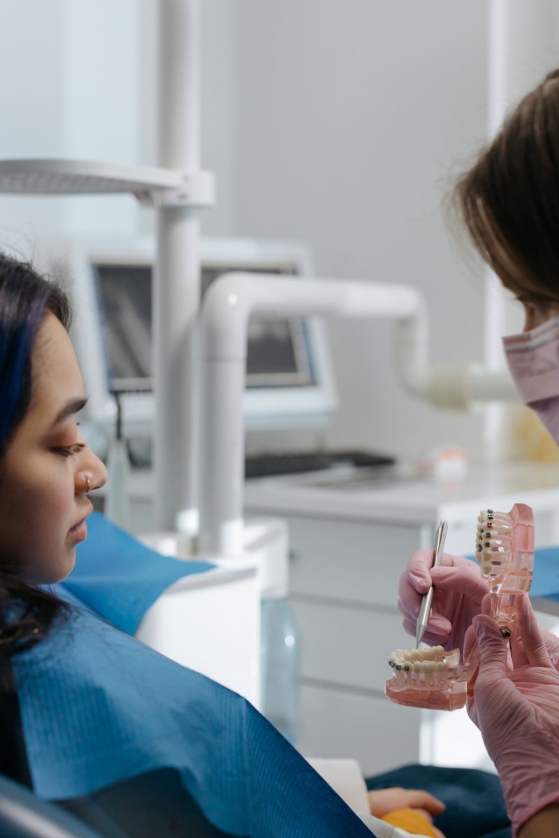Dentist explaining a treatment plan using a dental model