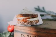 A Bacon and Egg Sandwich over a Wooden Box