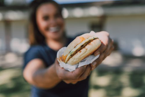 A Woman Holding a Sandwich