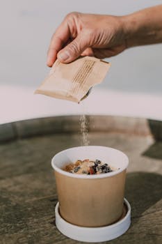 Oatmeal with toppings being prepared in an eco-friendly cup, perfect for healthy breakfast options.