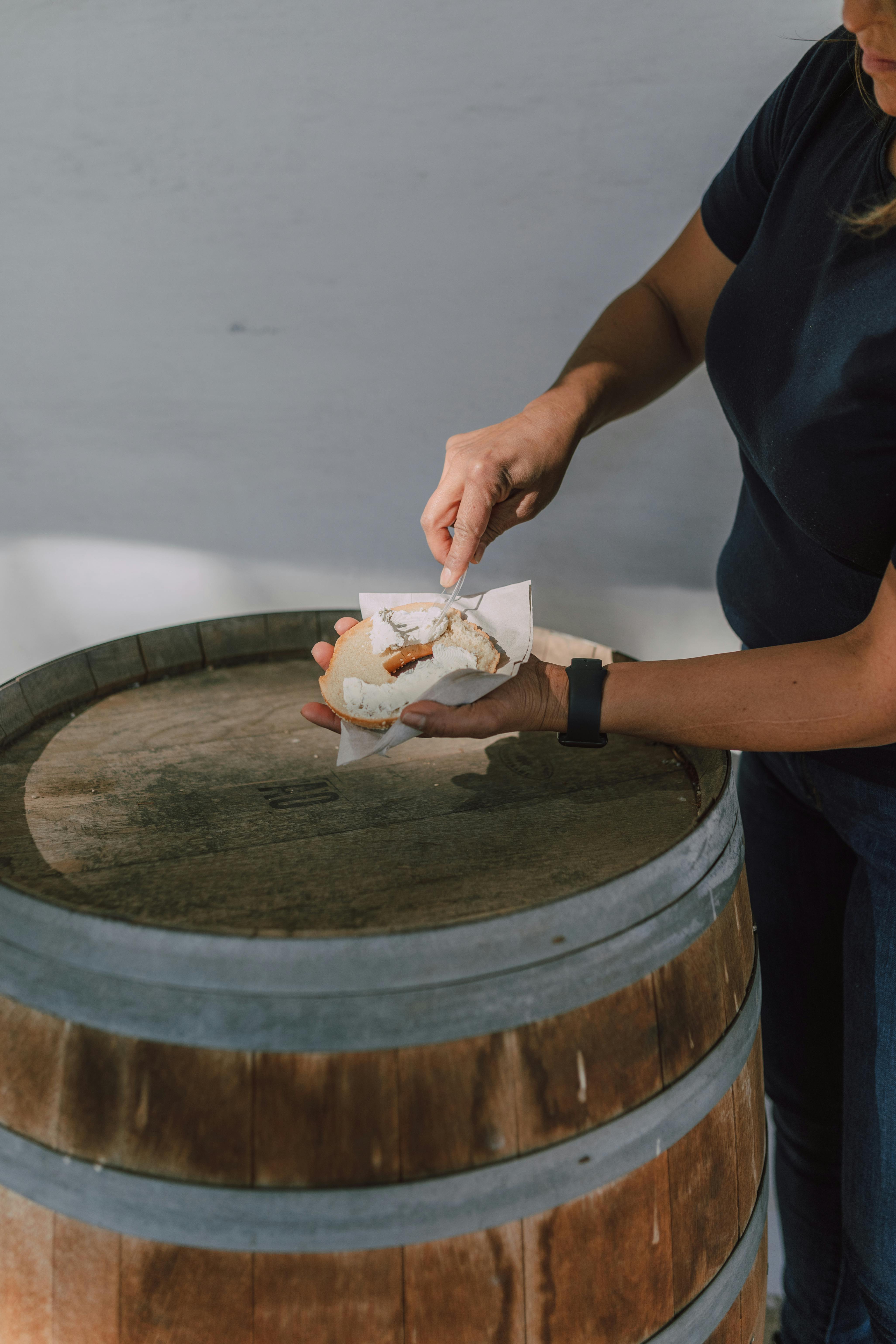 Spreading of Cream Cheese on a Bagel · Free Stock Photo
