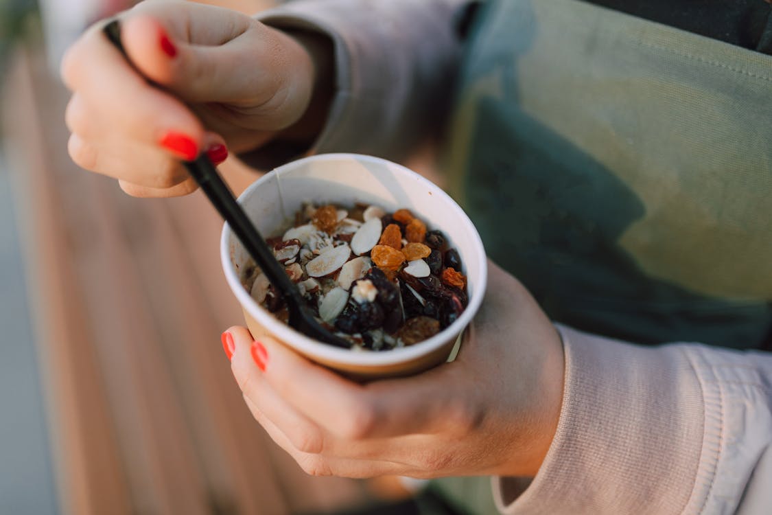 Free Person holding a Disposable Cup filled with Oatmeal Stock Photo