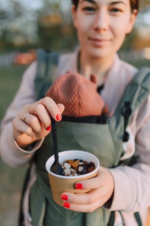 Free Woman holding a Disposable Cup filled with Oatmeal  Stock Photo