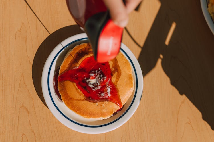 Pouring Of Maple Syrup On A Pancake