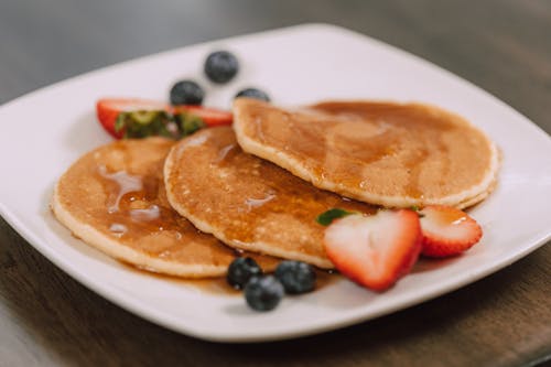 Free Pancakes and Fruits on a White Ceramic Plate Stock Photo