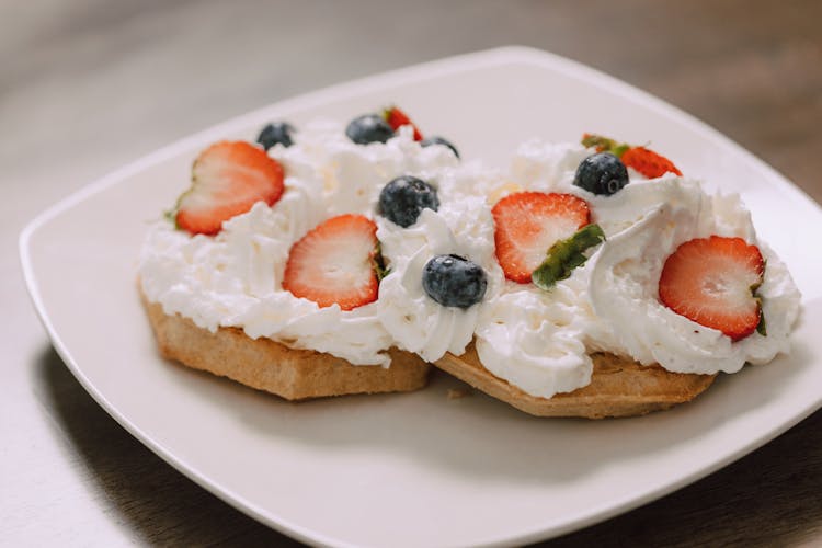 A Whipped Cream With Strawberry And Blueberry