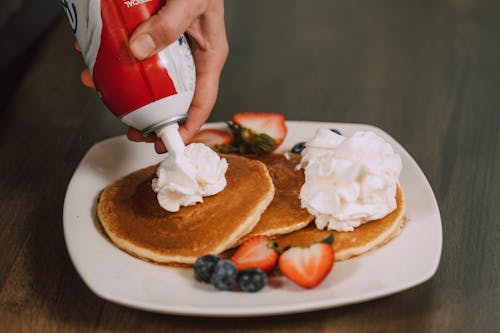 Free Pancakes with Fruits and Whipped Cream Stock Photo