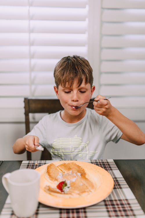 Free Kid eating his Breakfast  Stock Photo