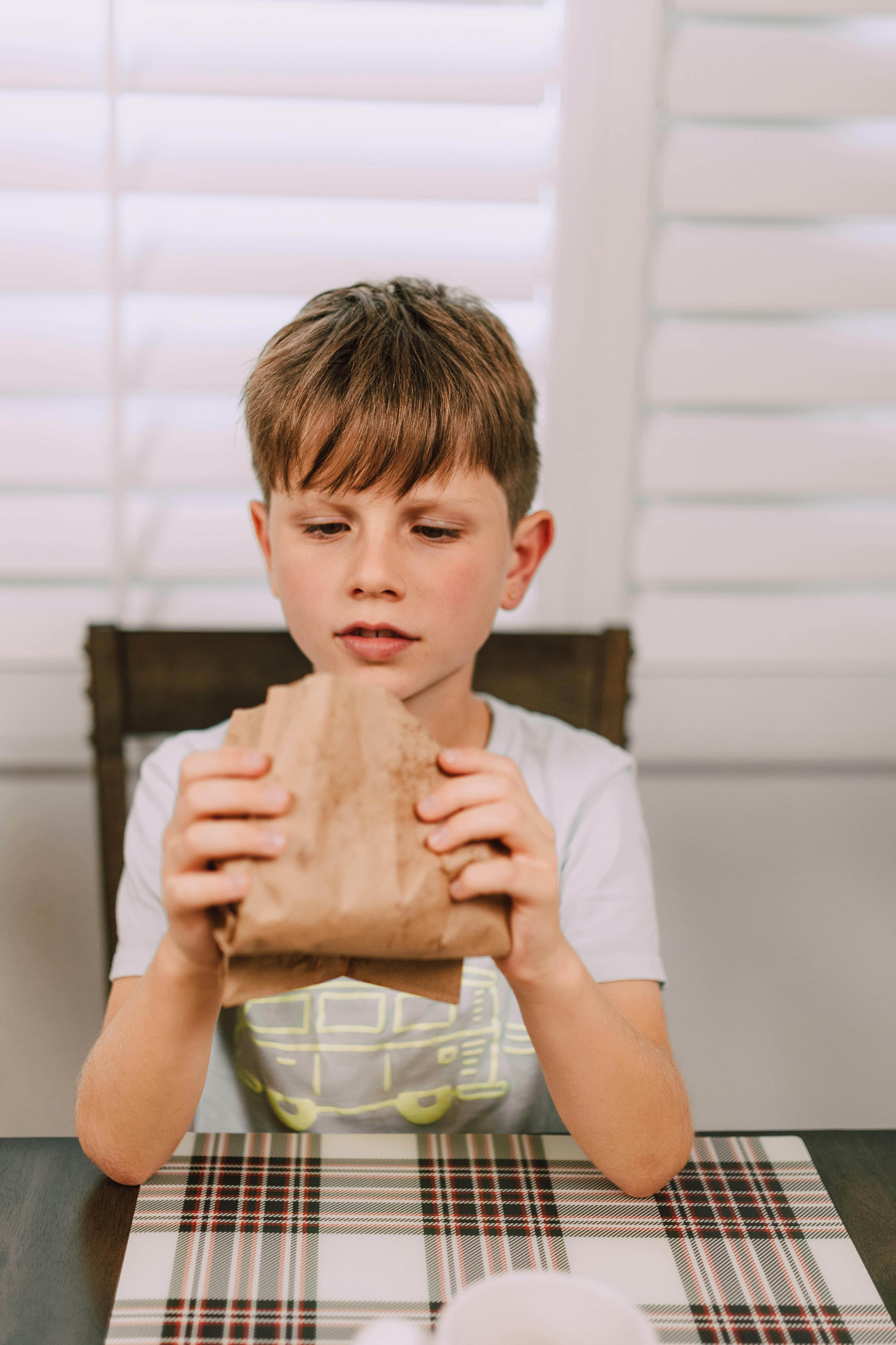 a young boy looking his food