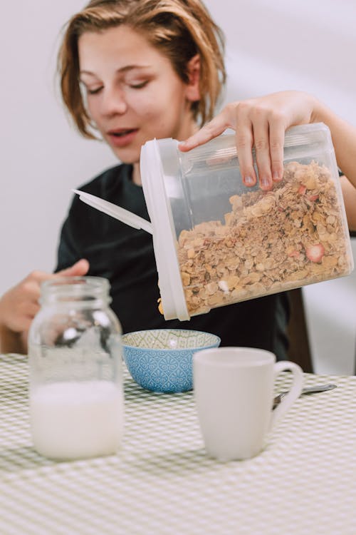 Free Pouring of Cereals on a Kid's Bowl  Stock Photo