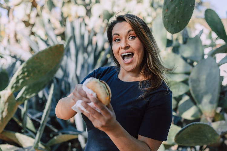 Happy Woman Holding A Sandwich 