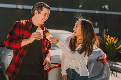 Man in White Sweater Kissing Woman in Red Shirt