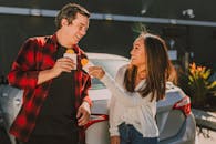 Man in White Sweater Kissing Woman in Red Shirt