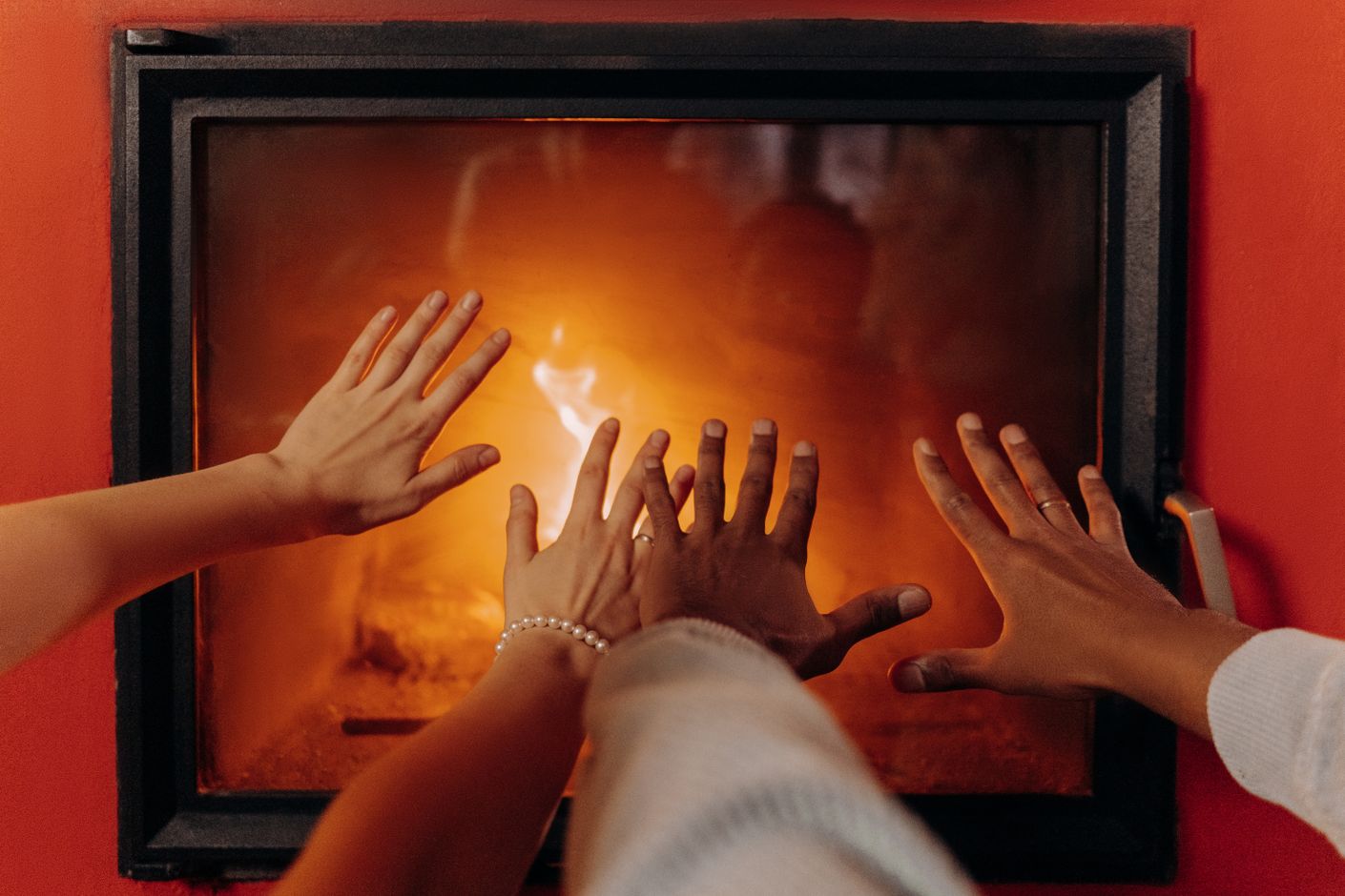 Hands warming by a fireplace