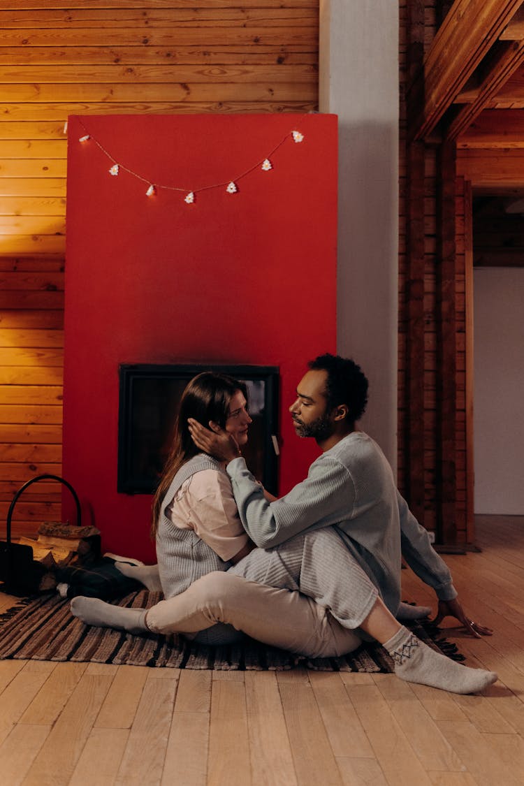 Couple Sitting Near Fireplace