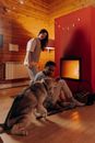 Couple Sitting Near Fireplace With Their Dog
