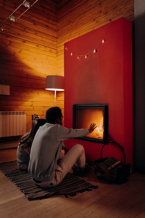 Couple Sitting Near Fireplace