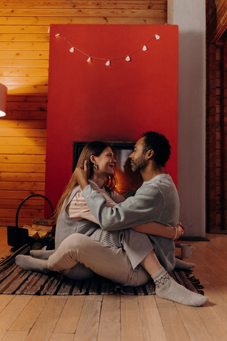 Couple Sitting Near Fireplace