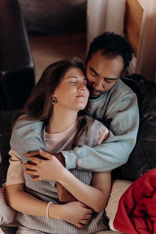 Man and Woman Sitting on Couch