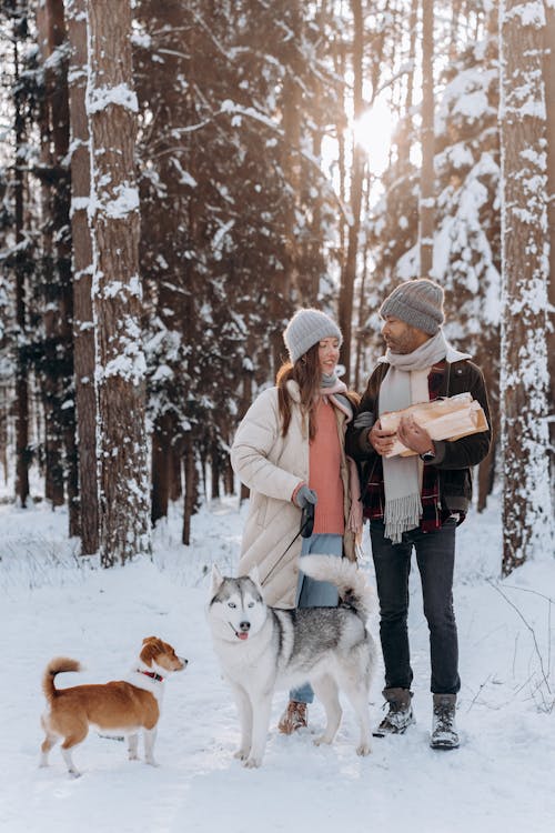 People Standing Outside With Their Pets