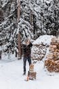 A Man Chopping Wood in a Winter Forest