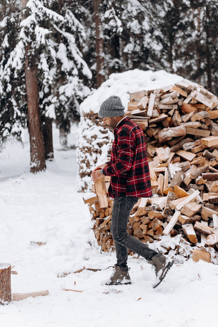 A Man With A Bonnet Getting Firewood 