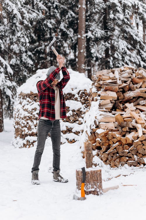 Free A Man Using an Axe to Chop Firewood Stock Photo
