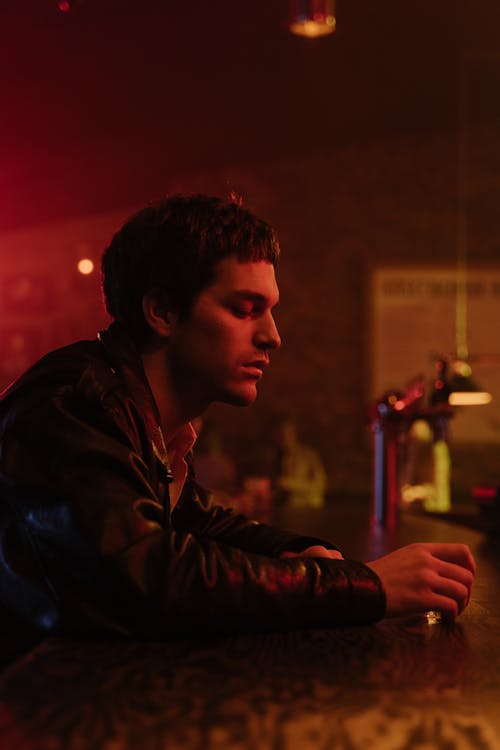 Free Side View of a Man Wearing a Leather Jacket Stock Photo