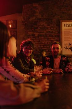 Casual gathering at a cozy bar as friends enjoy drinks together.