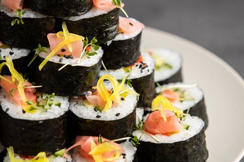 Free A close-up of beautifully arranged sushi rolls with diverse toppings, showcasing vibrant colors and fresh ingredients. Stock Photo
