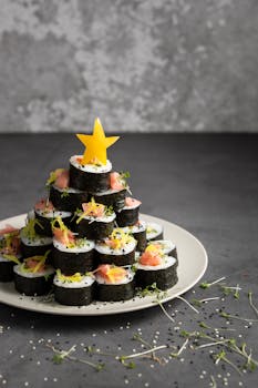 Creative sushi roll arrangement resembling a tree, topped with a star.