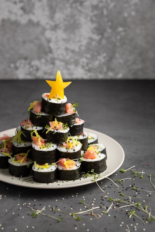 Free Creative sushi roll arrangement resembling a tree, topped with a star. Stock Photo