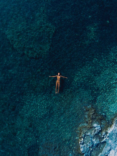 Woman Swimming on Turquoise Water of the Sea