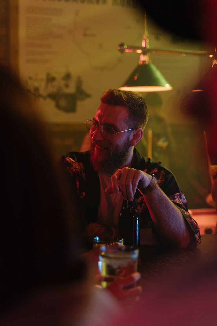 A Man With A Bottle Of Beer Smiling