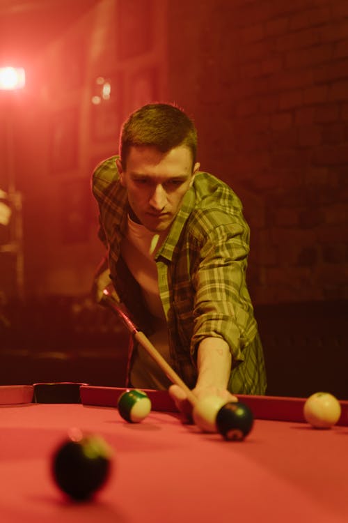 Man Playing Billiards in a Bar